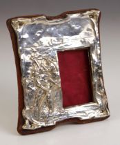 An Edwardian silver photograph frame, possibly George Houston, Birmingham 1905, the shaped frame