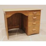 A George V honey oak kneehole desk, with an arched kneehole recess and bank of four graduated