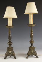 A pair of 19th century brass lamp bases, each with turned columns and raised on triangular shaped