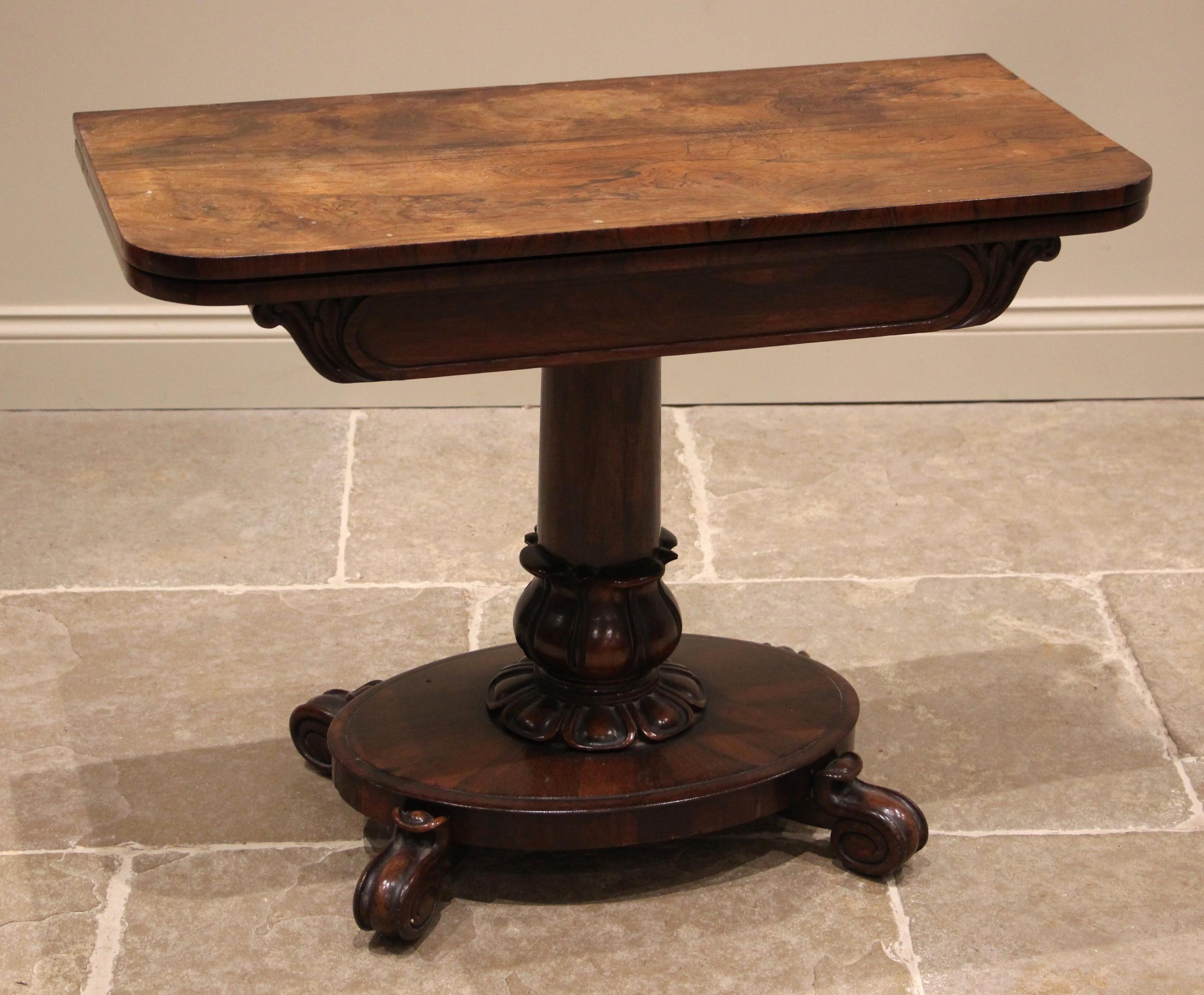 A William IV rosewood pedestal card table, the rectangular folding top opening to a circular baize