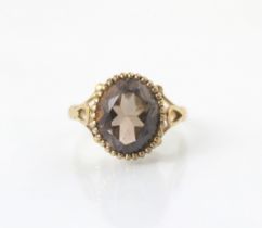 A 19th century style untested citrine dress ring, the central oval cut stone within grooved raised