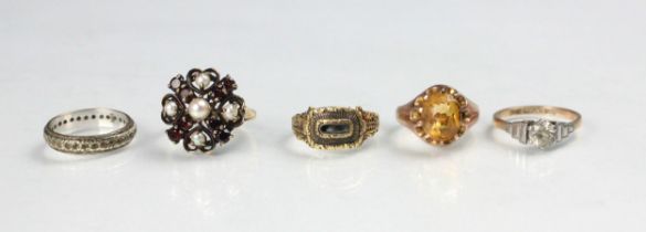 A 19th century style yellow metal mourning ring, the central vacant locket within carved mount and