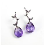 A pair of Edwardian style untested briolette cut amethyst earrings, the stylised foliate studs set