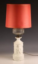 A Victorian Hinks & Sons Patent oil lamp, with glass reservoir above a white glaze ceramic base