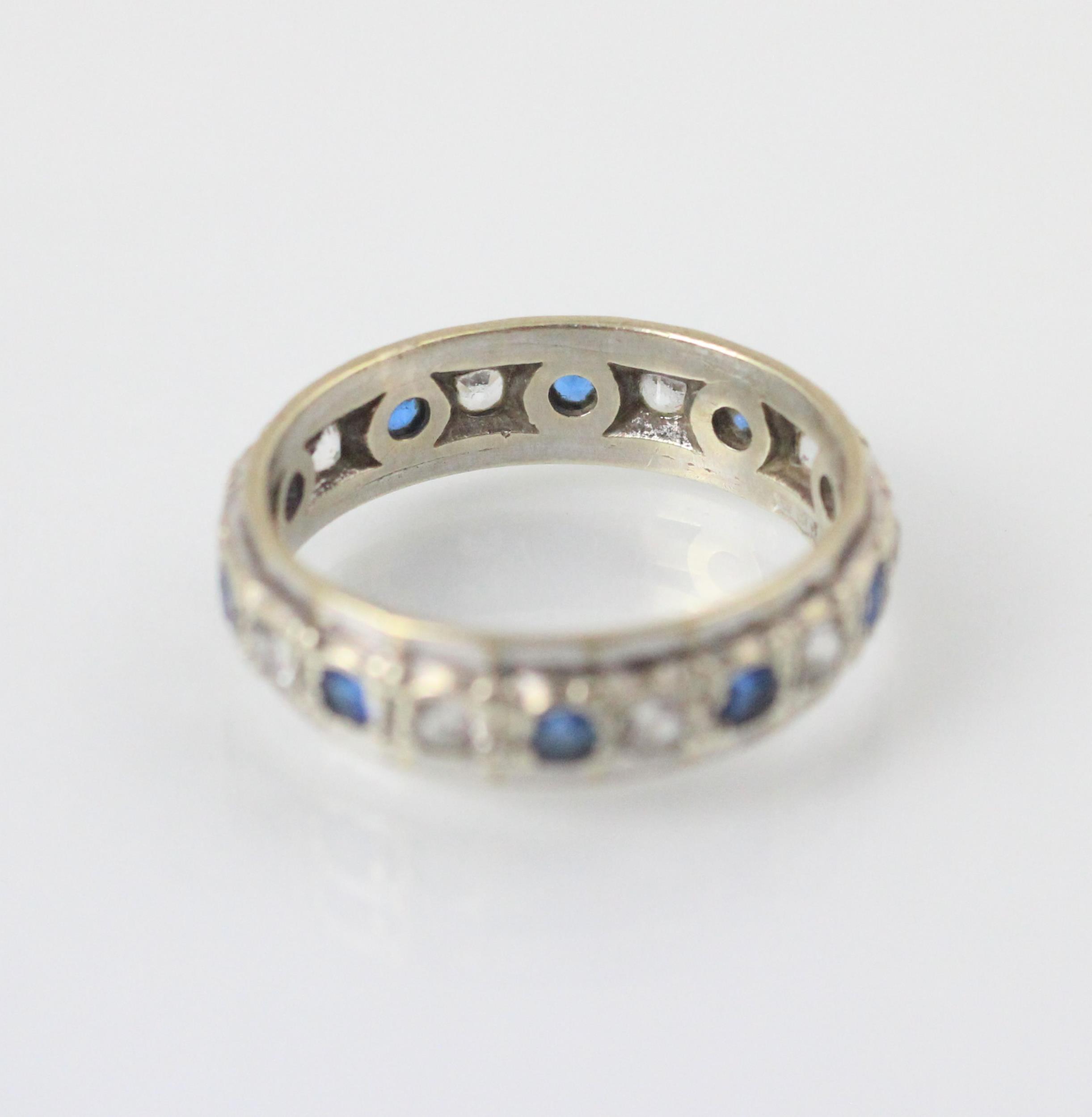 A 9ct white gold untested white sapphire and blue sapphire full eternity ring, the round cut blue - Image 2 of 2