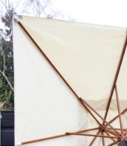 A large garden/patio parasol, by Skagerak, Denmark, folding white fabric cover upon a hardwood