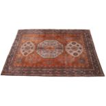 A kork work fine woven Caucasian design rug, the terracotta ground centered with three geometric