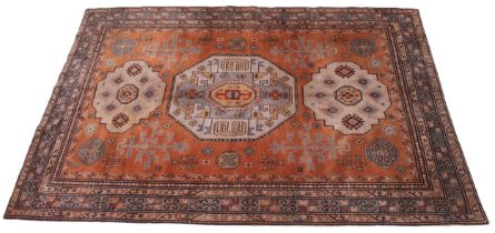 A kork work fine woven Caucasian design rug, the terracotta ground centered with three geometric