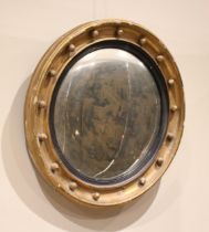 A Regency style giltwood and gesso convex wall mirror, late 19th century, the moulded frame