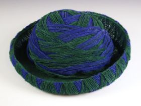A vintage 1960’s Miss Dior woven and netted hat, in emerald green and deep blue, bearing 'Miss