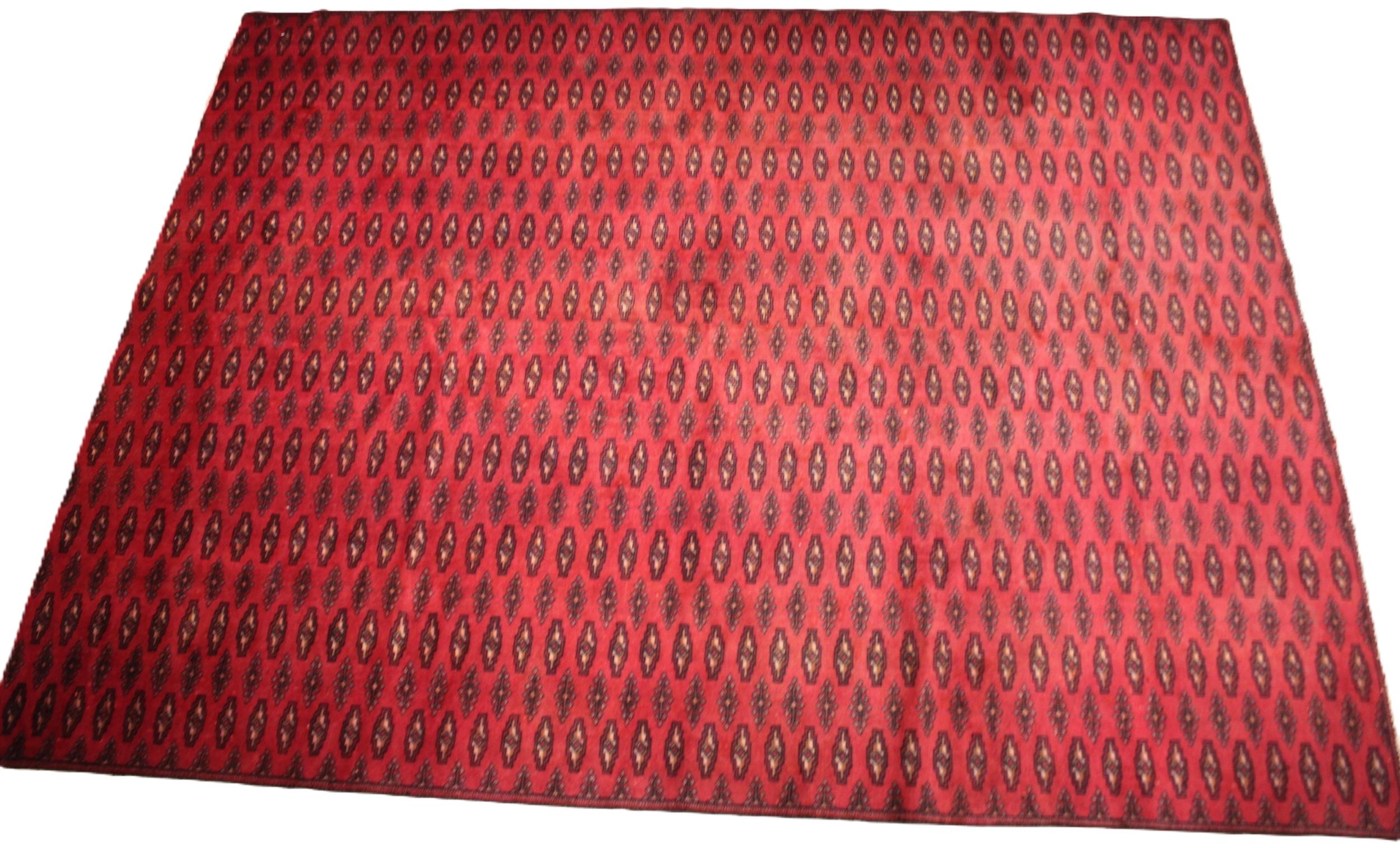 A red ground Turkmen carpet, with all over Bokhara guls, punctuated by rows of lozenge shaped