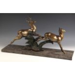 An Art Deco bronze animal group modelled as a leaping stag and hind, early 20th century, probably