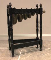 An early 20th century oak framed bell xylophone, the tapering frame carved with flowerhead roundels,
