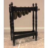 An early 20th century oak framed bell xylophone, the tapering frame carved with flowerhead roundels,