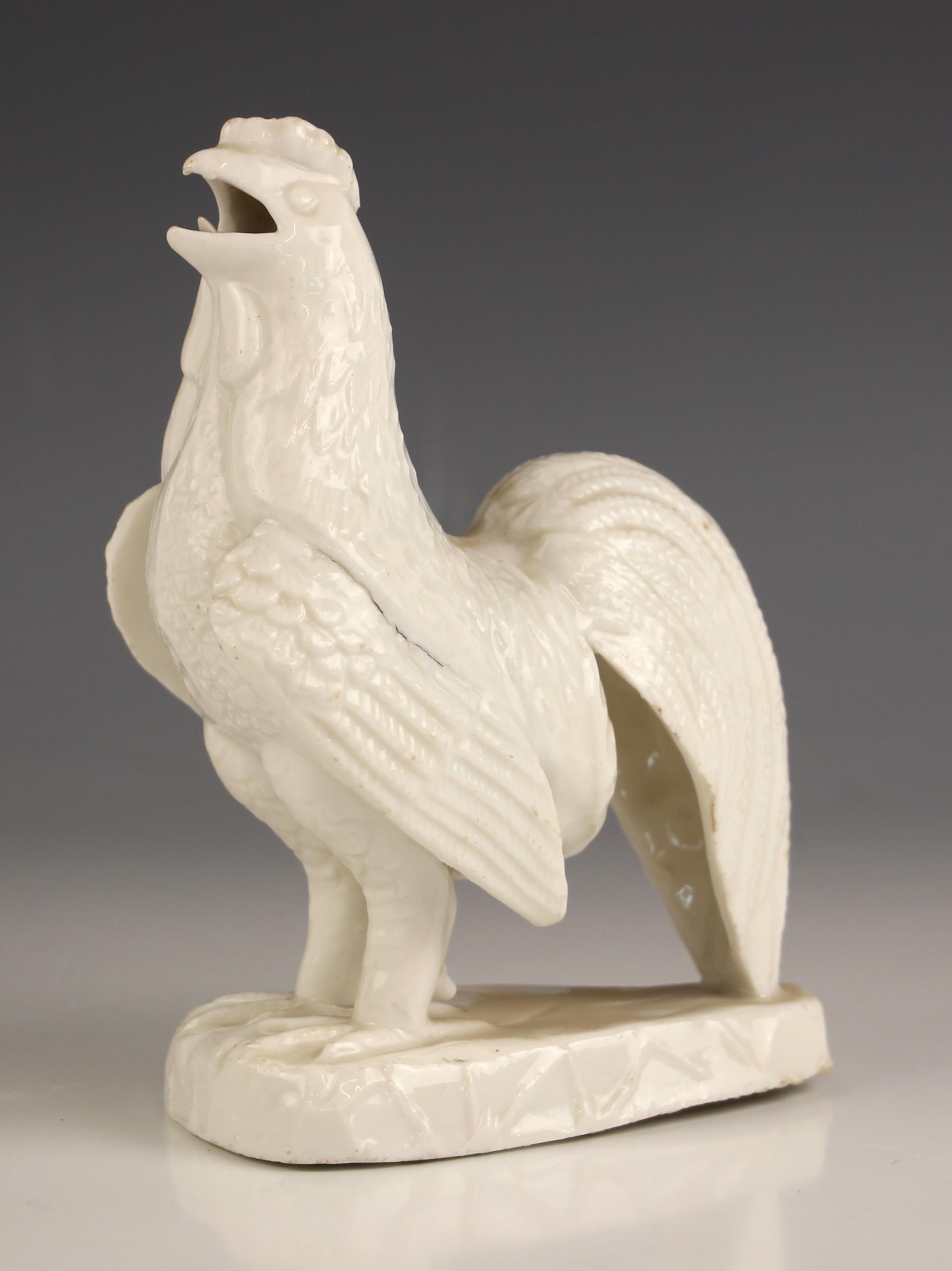 A Chinese porcelain Blanc De Chine model of a cockerel, circa 1700, 17cm high (at fault)