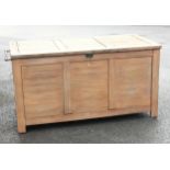 An outdoor teak storage chest, of slatted form with a hinged cover and fitted side handles, upon