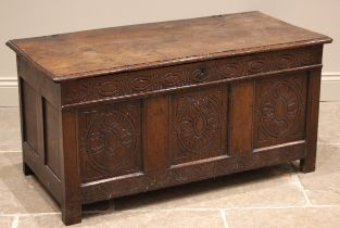 A late 17th/early 18th century oak coffer, the hook and eye hinged moulded plank top, above a