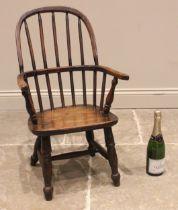 A 19th century child's ash Windsor elbow chair, the hoop back over a slab seat upon turned legs