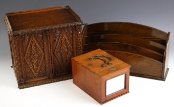 A Victorian carved oak stationery cabinet, the two doors opening to a compartmented interior with