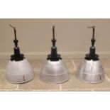 Three Simplex aluminum industrial light shades, mid 20th century, of typical domed form, below a