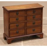 An early 20th century and later constructed figured walnut collector's chest, the quarter veneered