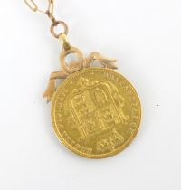 A mounted Victorian half sovereign, dated 1885, with shield back, mounted with bow shaped pendant