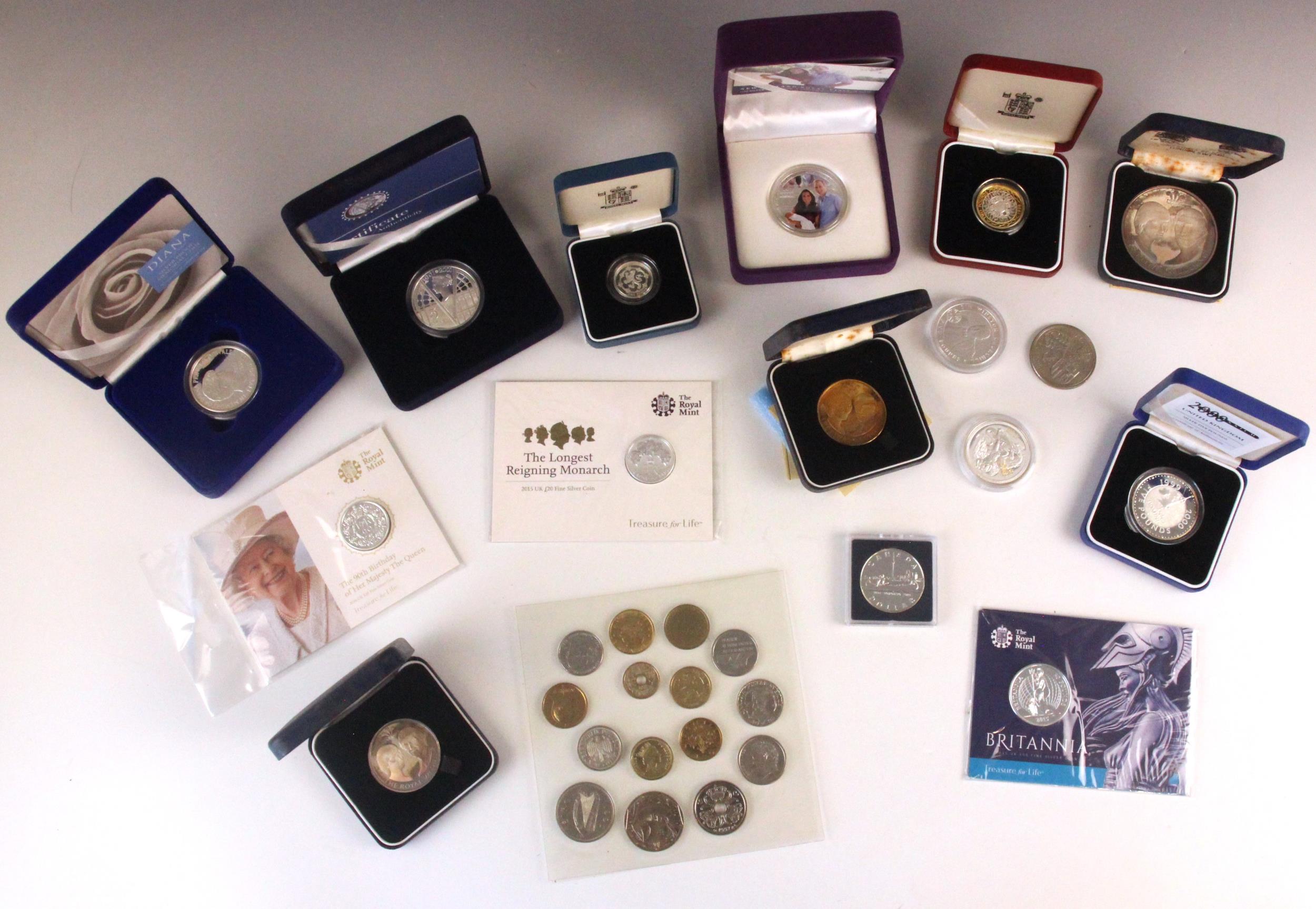 A collection of British commemorative coins, including silver proof £2 coin, £20 silver coins,