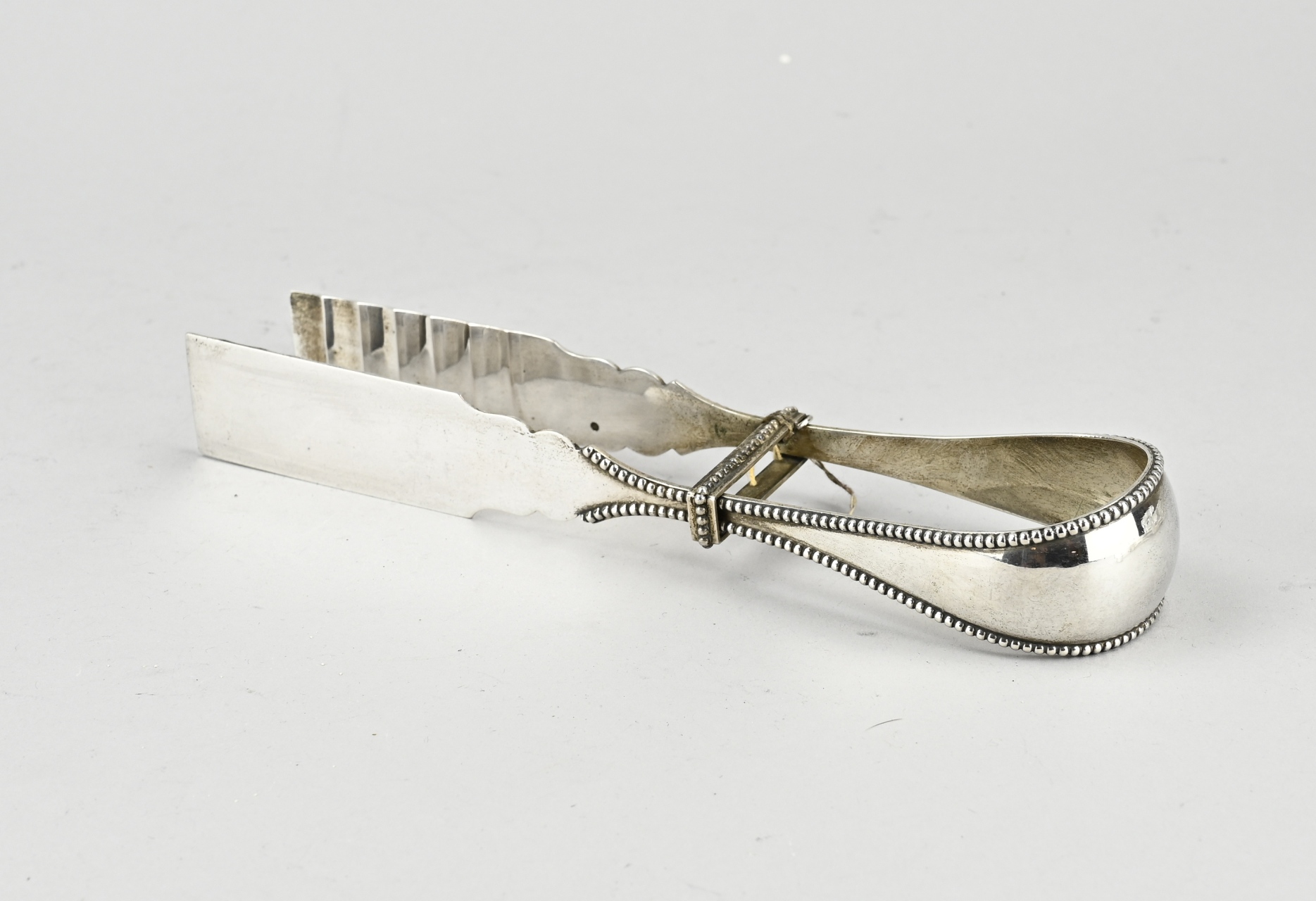 Silver asparagus tongs with pearl edge