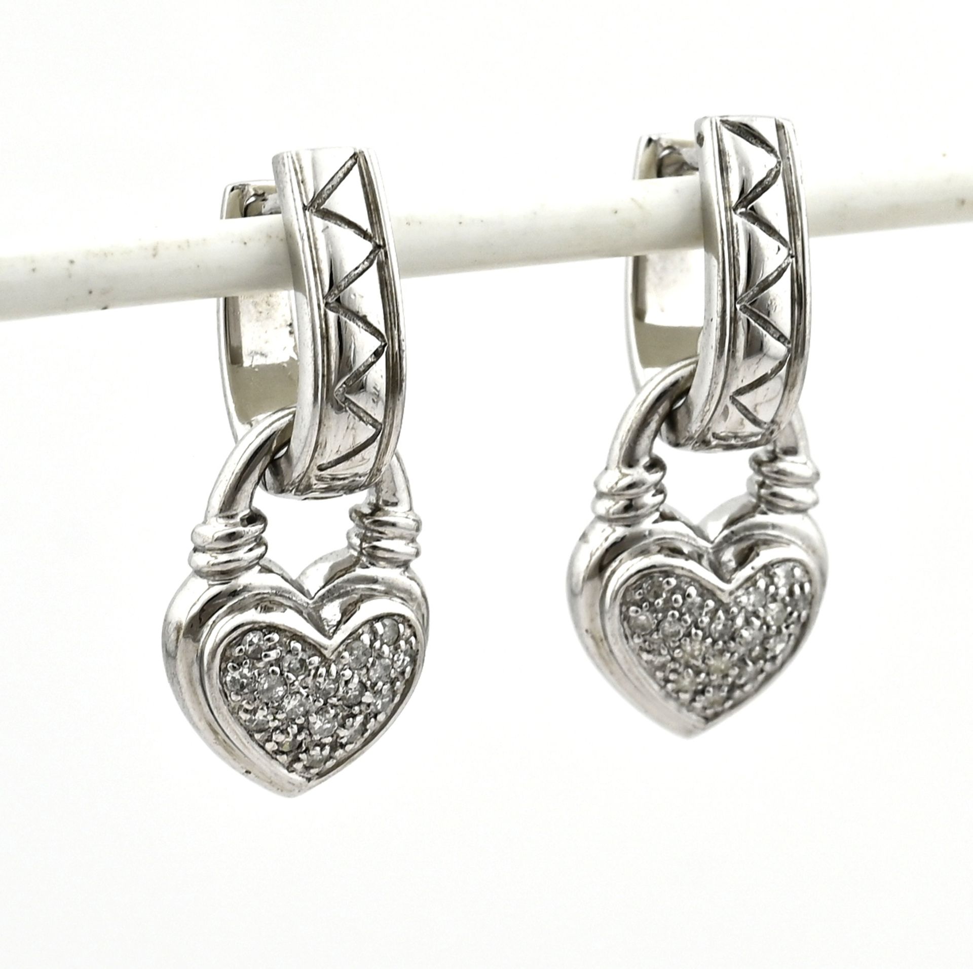Silver hoop earrings with heart pendants with diamonds