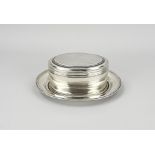 Silver cookie jar on saucer