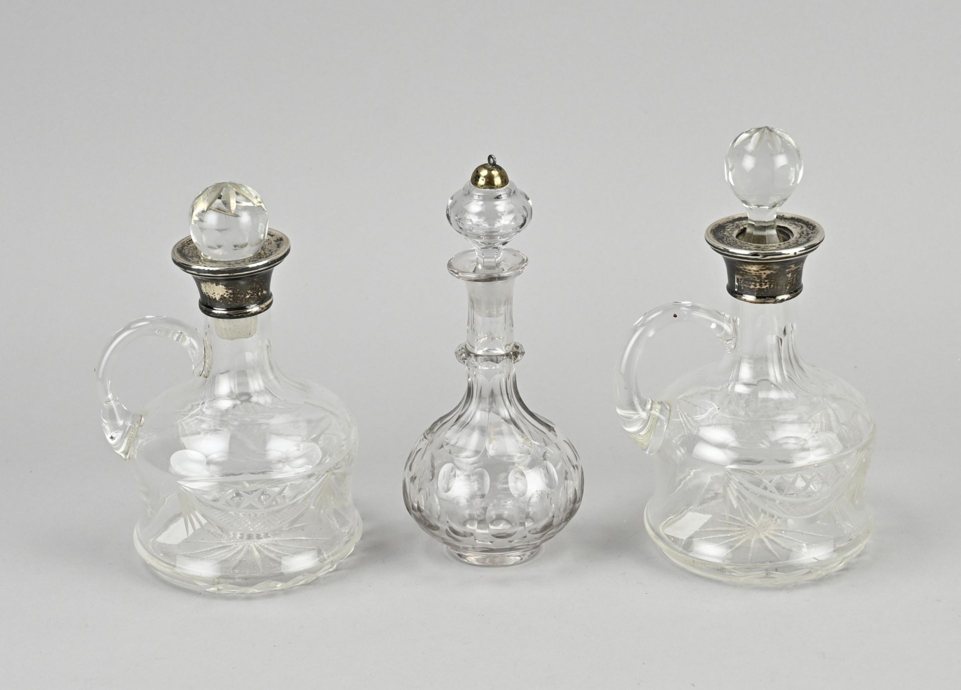 3 Decanters with silverware