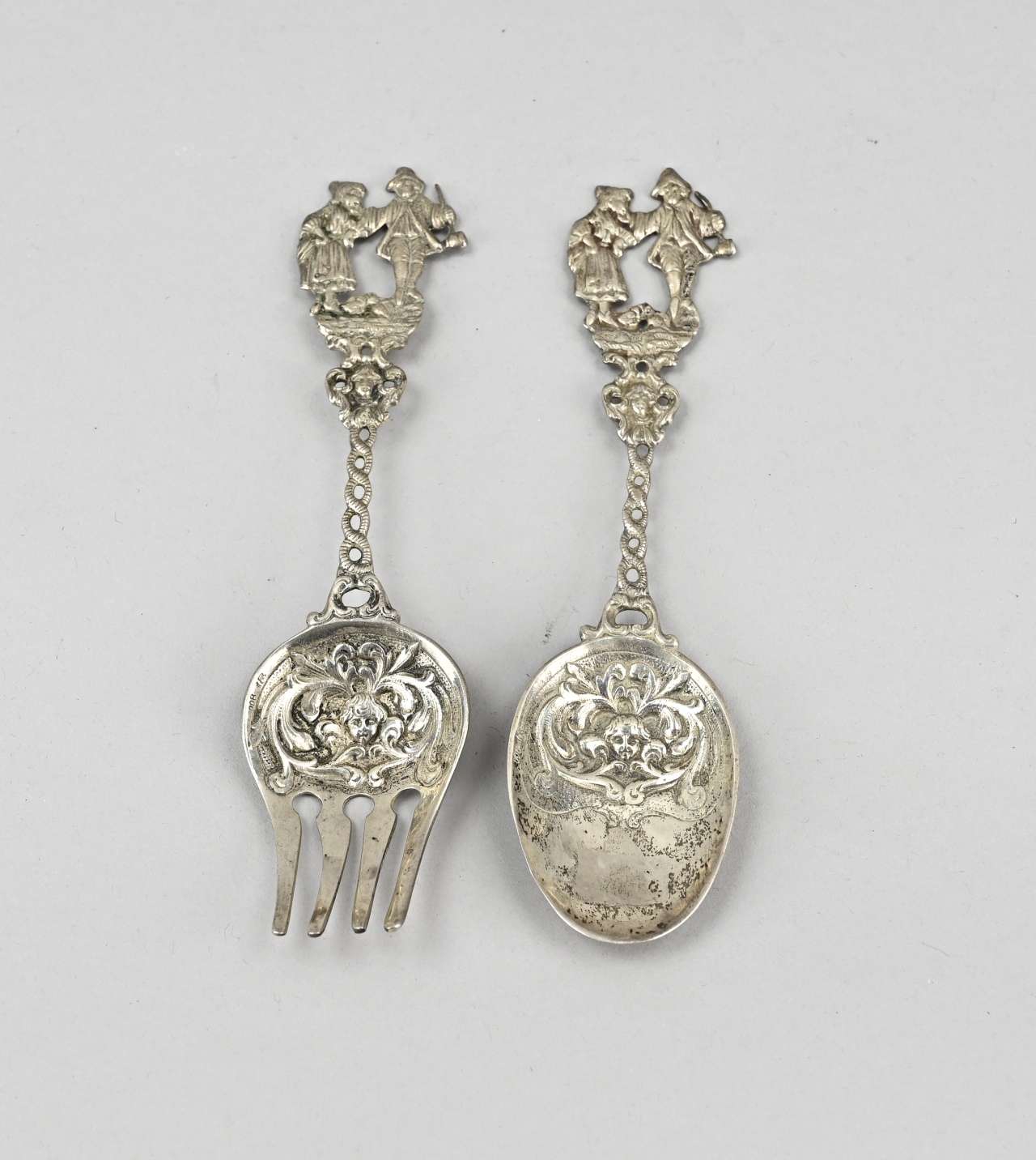 Silver spoon and fork with figures