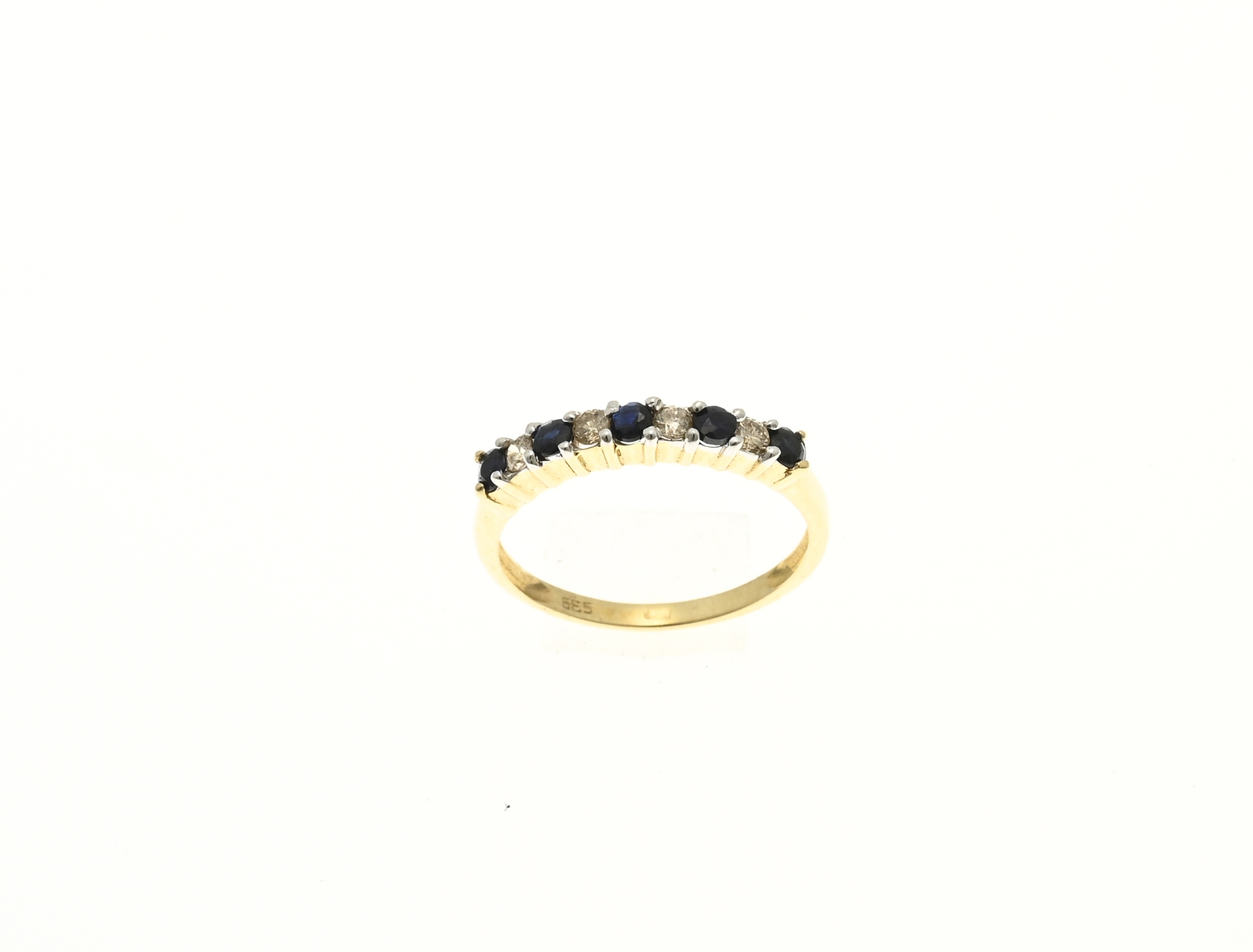 Yellow gold row ring with diamond and sapphire.