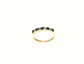 Yellow gold row ring with diamond and sapphire.