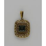 Gold pendant with gemstone