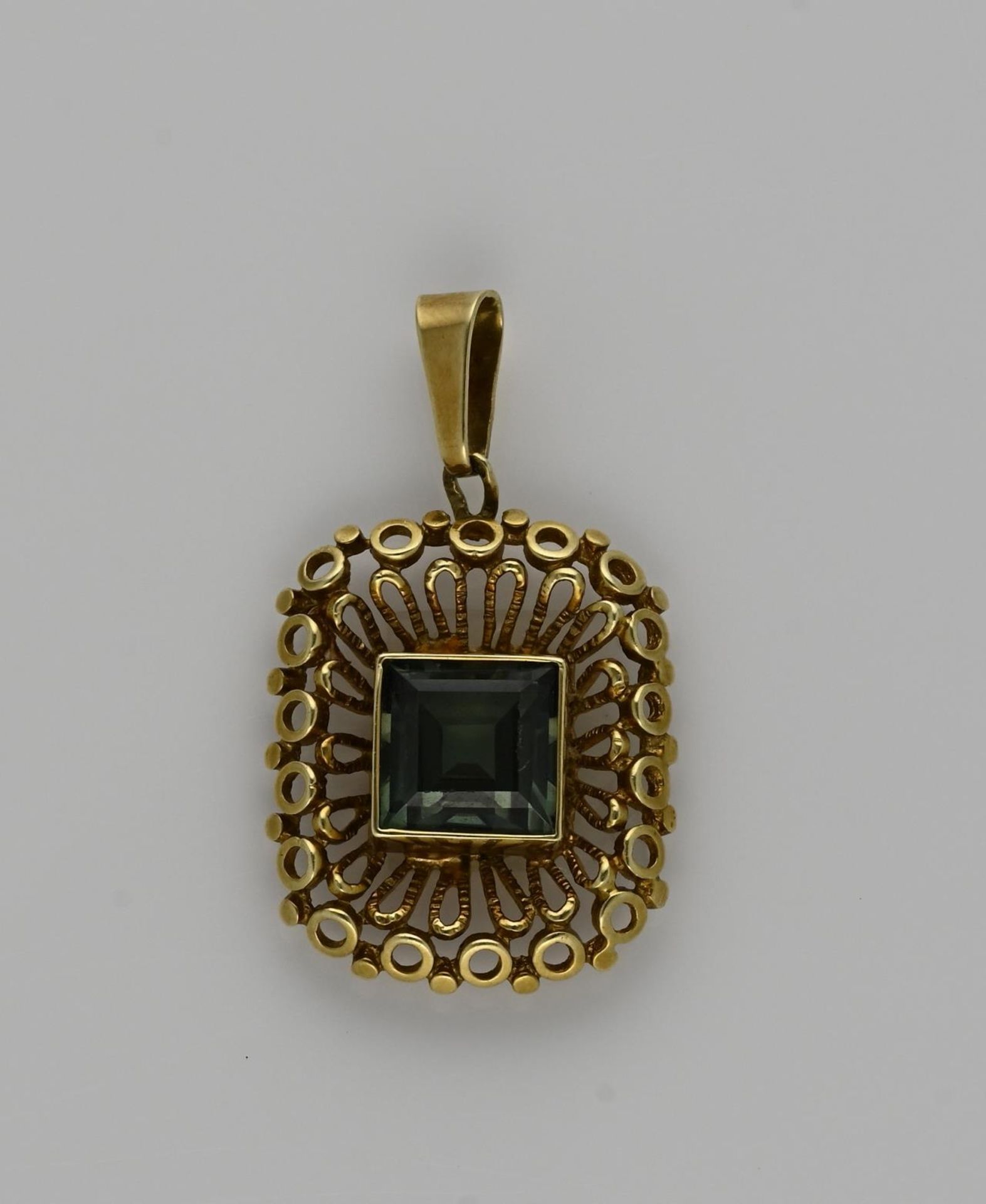 Gold pendant with gemstone