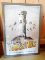 Banksy Framed "Visit Historic Palestine" poster with embossed Walled Off Hotel stamp. 60cm x 42cm.