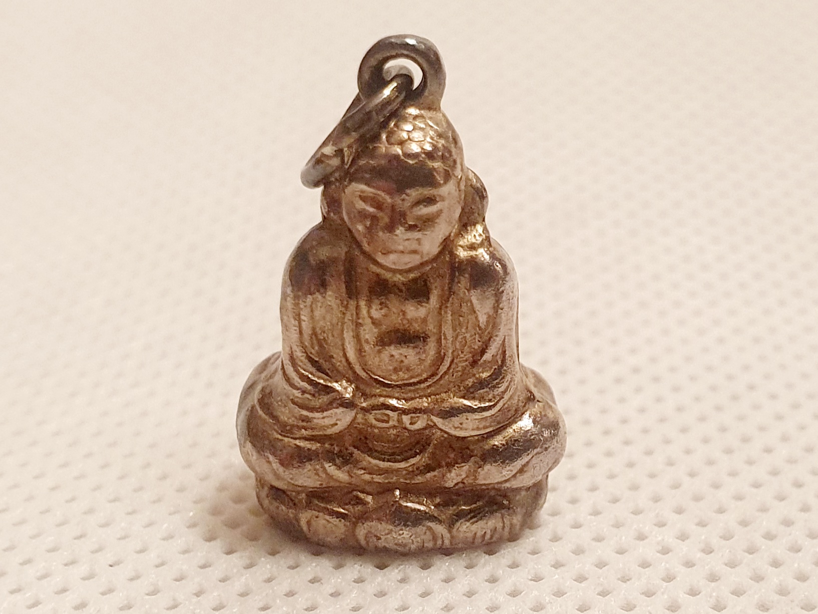 Small White Medal Buddah Pendant with worn mark to base
