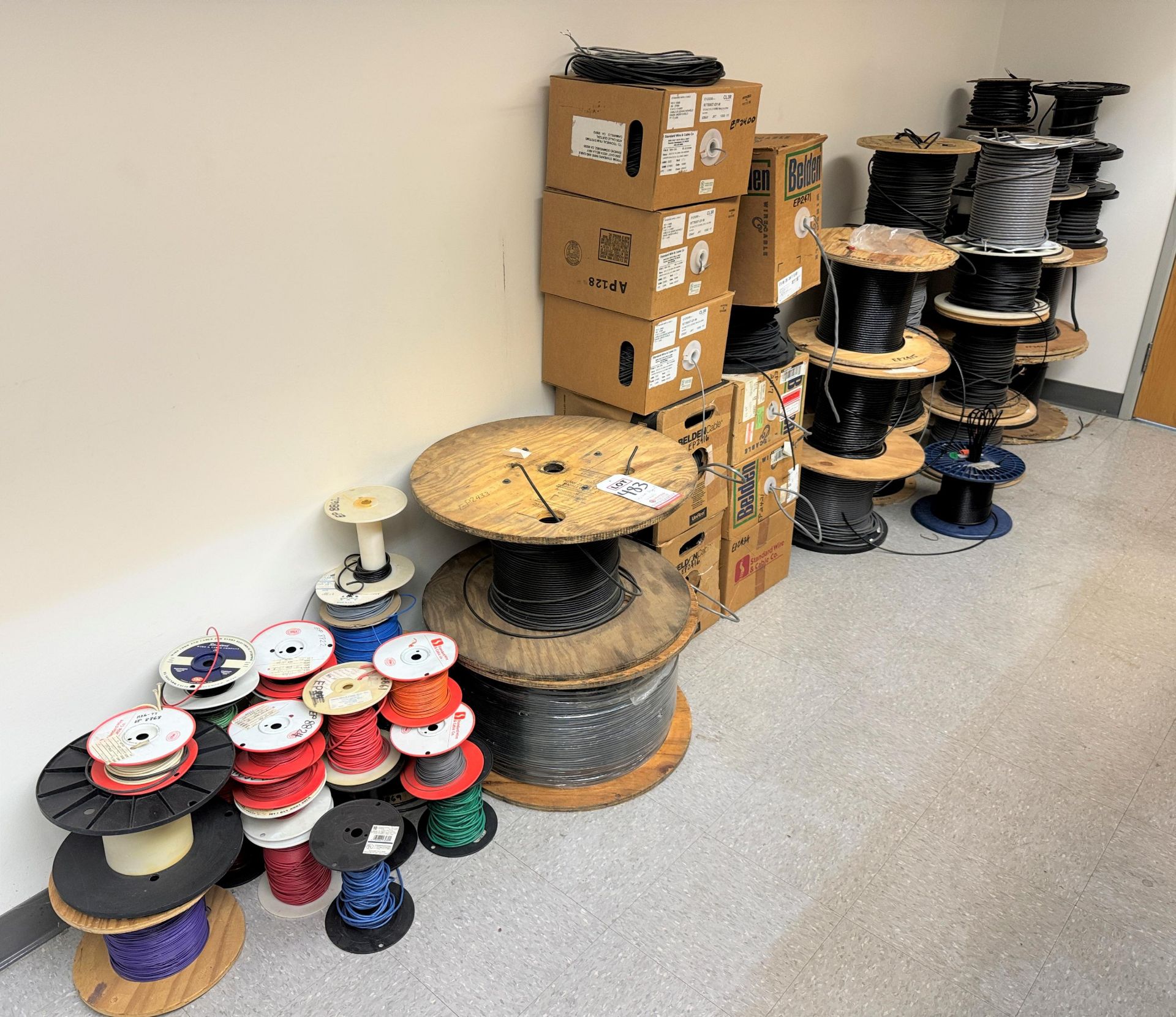 LOT - ALL WIRE SPOOLS IN FRONT OF WALL, OVER (50) SPOOLS