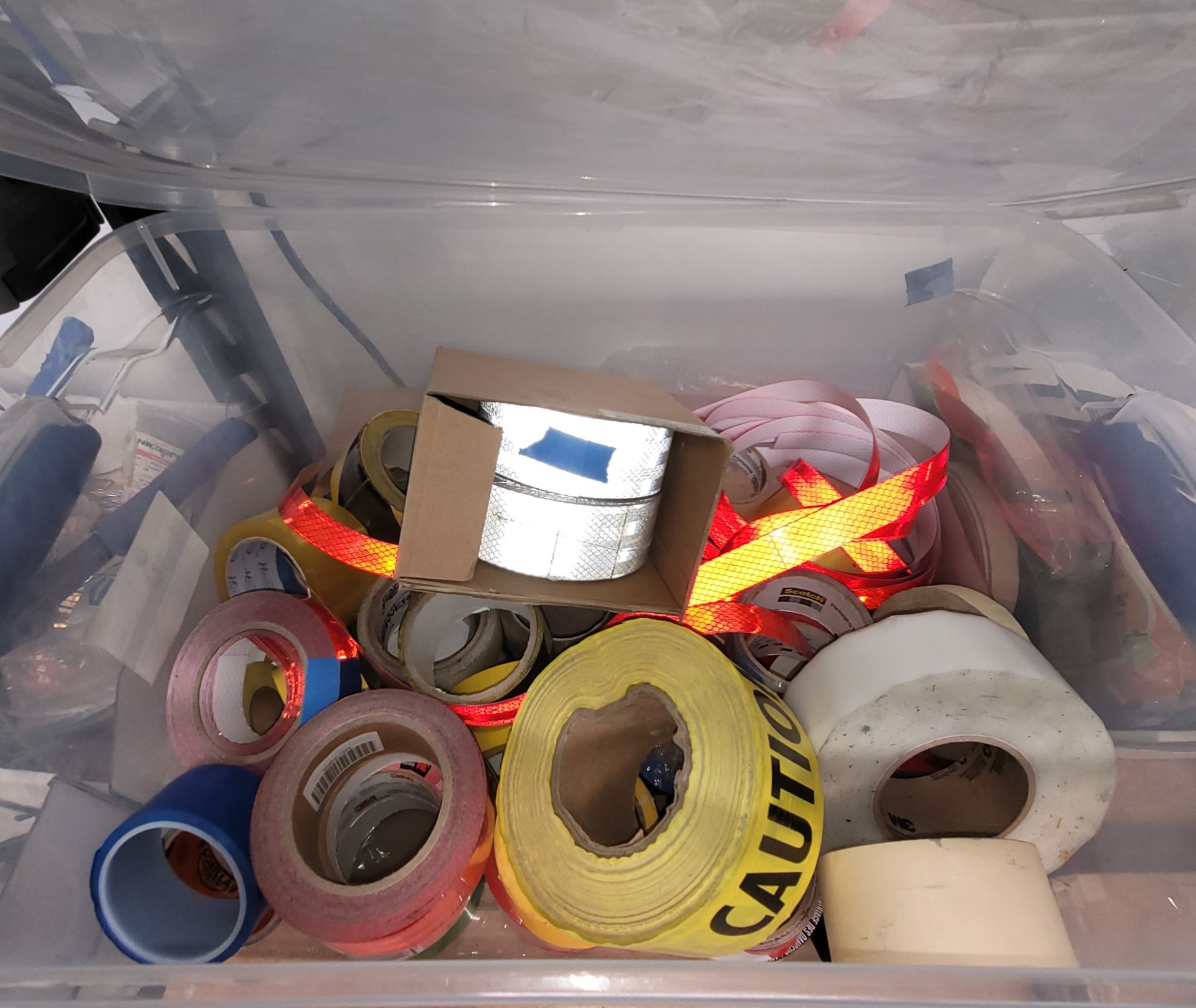 LOT - CLEAR TOTE CONTAINING MULTIPLE ROLLS OF VARIOUS TAPES, CAUTION TAPE, REFLECTIVE TAPE, ETC. - Image 2 of 2