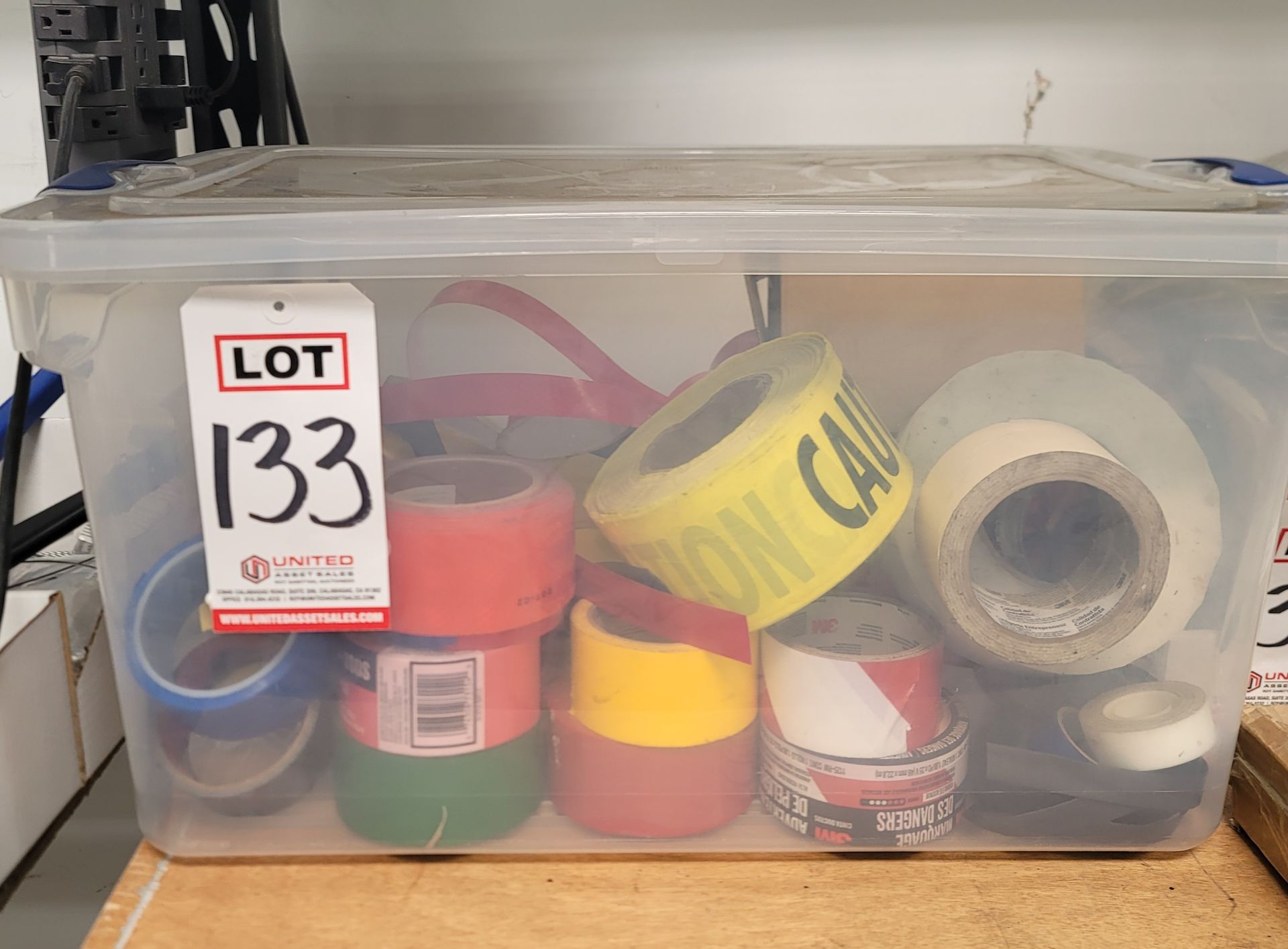 LOT - CLEAR TOTE CONTAINING MULTIPLE ROLLS OF VARIOUS TAPES, CAUTION TAPE, REFLECTIVE TAPE, ETC.