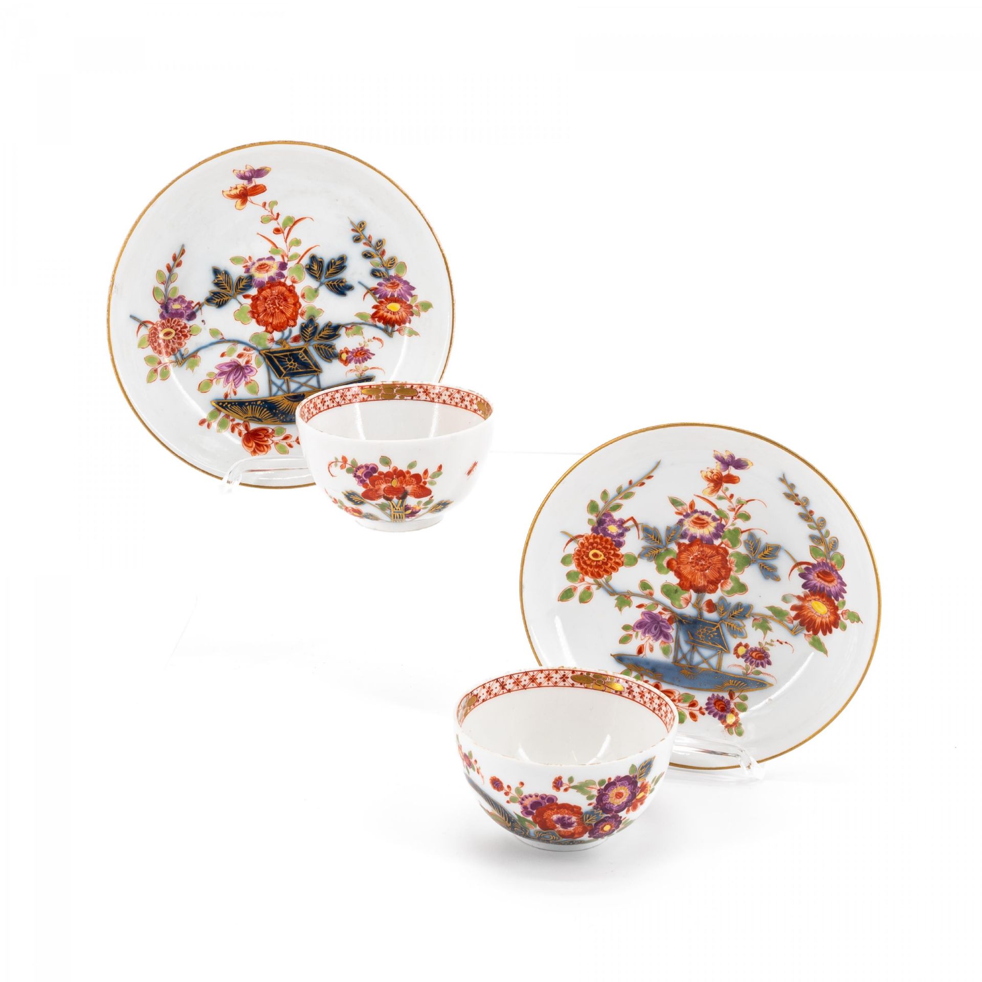 Meissen: TWO PORCELAIN TEA BOWLS WITH SAUCERS AND DECORATED-OVER TABLE PATTERN