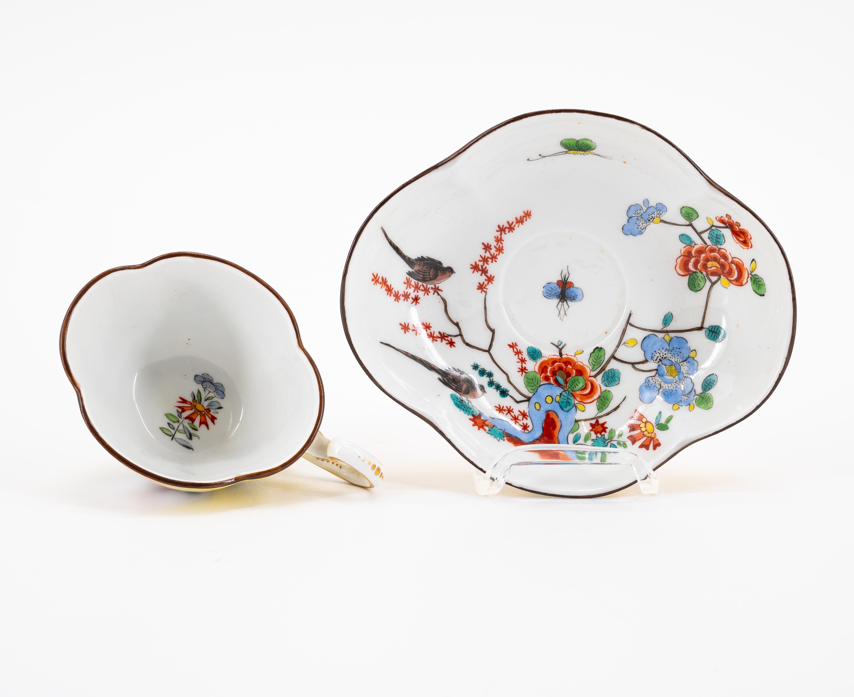 A PORCELAIN CUP AND THREE SAUCERS WITH YELLOW GROUND AND BIRD AND ROCK DECORATION - Image 7 of 8