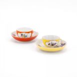 TWO PORCELAIN CUPS AND SAUCERS WITH YELLOW AND ORANGE COLOURED GROUND AS WELL AS FLORAL DECOR