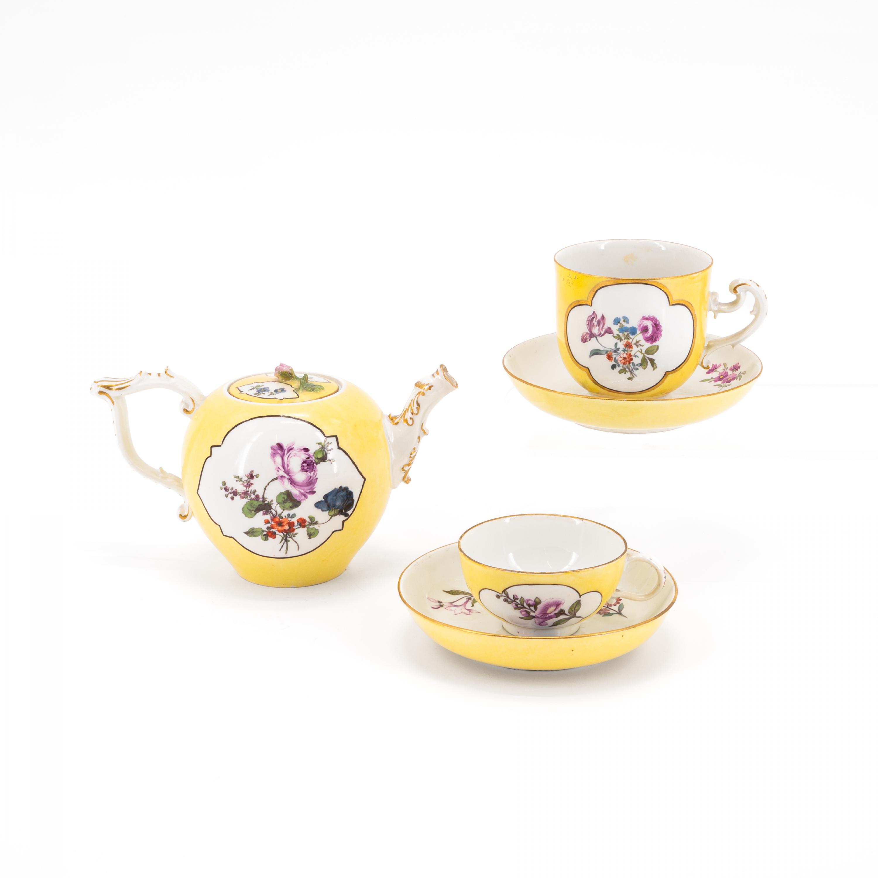 PORCELAIN TEA POT, TWO CUPS AND SAUCERS WITH YELLOW GROUND AND OMBRÉ FLORAL PAINTING