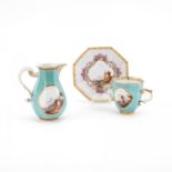 OCTAGONAL PORCELAIN CREAM JUG; HANDLES CUP AND SAUCER WITH TURQUOISE BACKGROUND AND LANDSCAPE DECORA