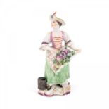 PORCELAIN LADY WITH STRAW HAT AND FLORAL APRON