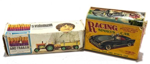 A tinplate & plastic constructed boxed pair