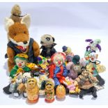 Quantity of porcelain clowns, wooden nesting dolls, and similar