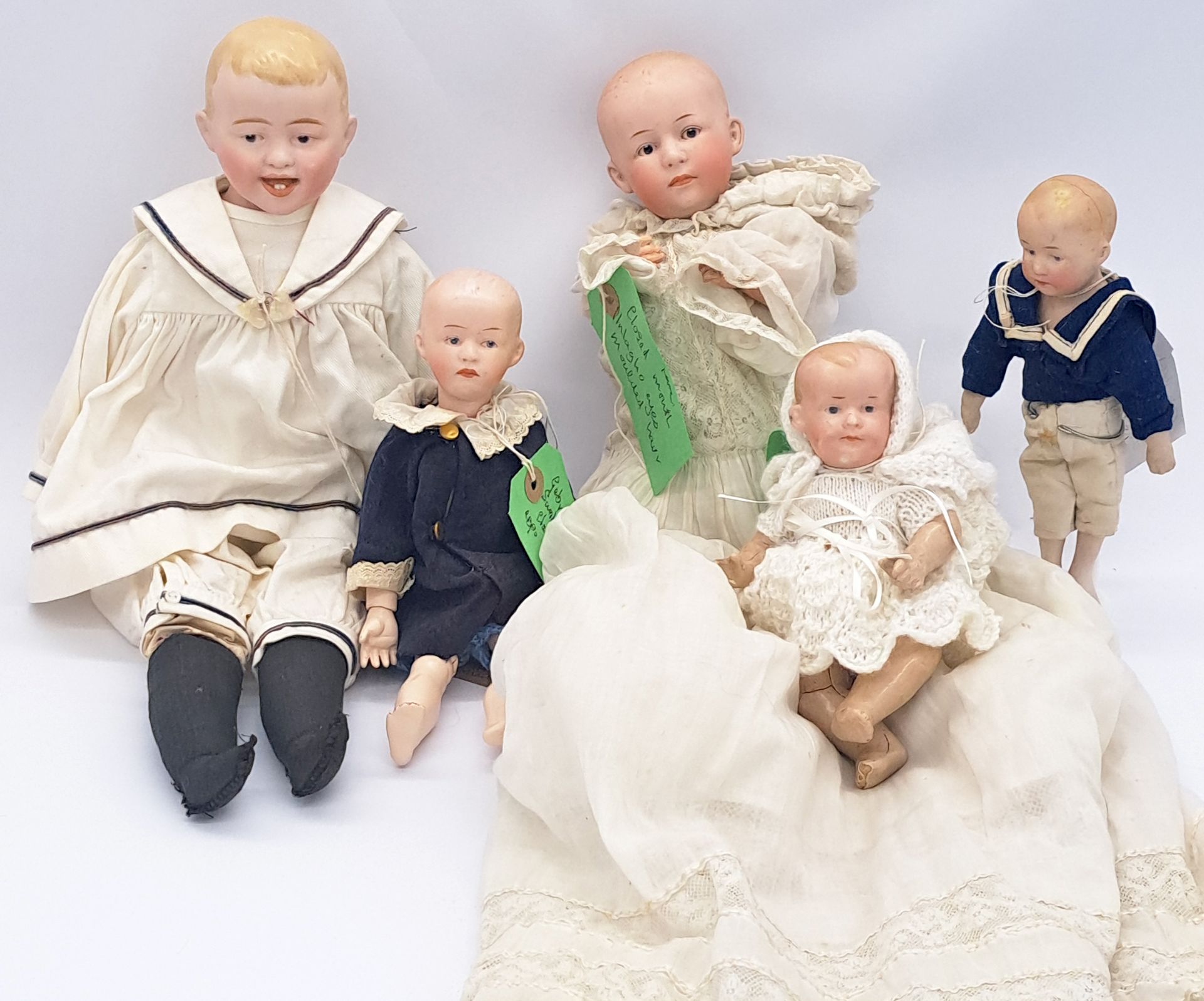 Group of character bisque dolls with intaglio eyes, including Gebruder Heubach 76/02